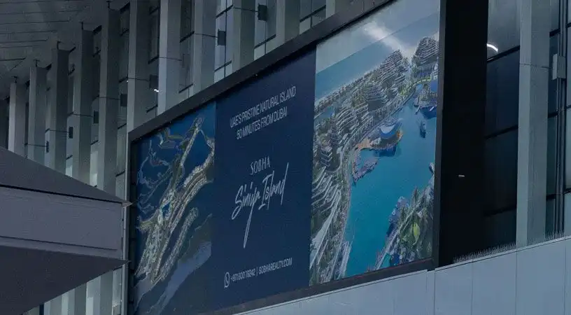 Large indoor wall billboard promoting real estate project