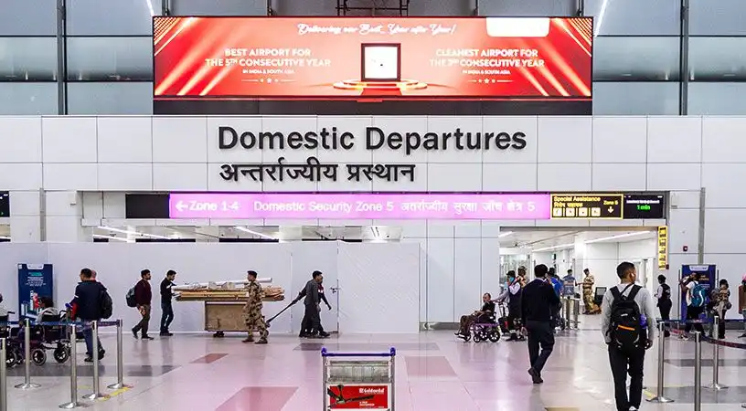Domestic departures entrance with large promotional banner above