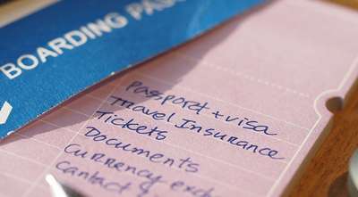 Boarding pass with handwritten travel checklist