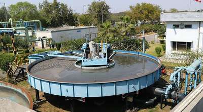 Circular water treatment tank with pipes and machinery