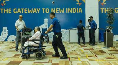 Airport staff assisting wheelchair passenger