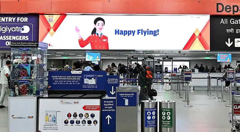 Security entry area with promotional banner above screening zone